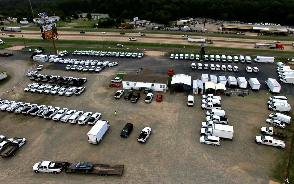 Used work trucks and vans on the T&B Auto Sales lot in Bryant, Arkansas